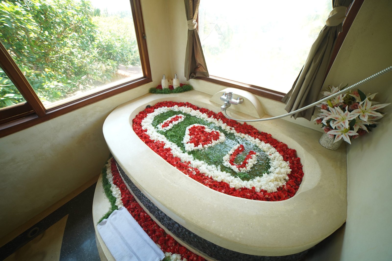 Bathtub decorated with flower petals called Blossom Bath Ritual