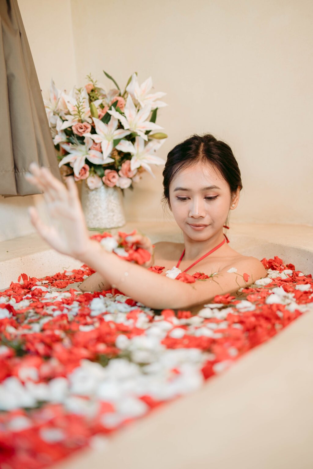 Person in flower-filled bathtub for Blossom Bath Ritual