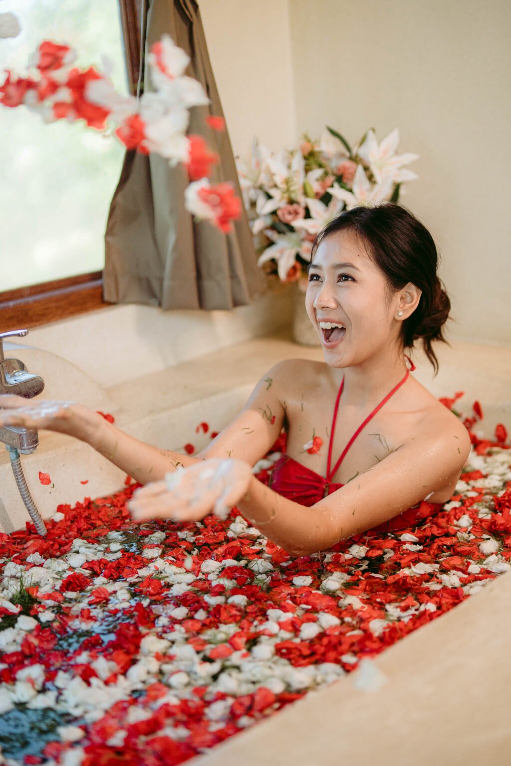 Person in floral petal bath for Blossom Bath Ritual