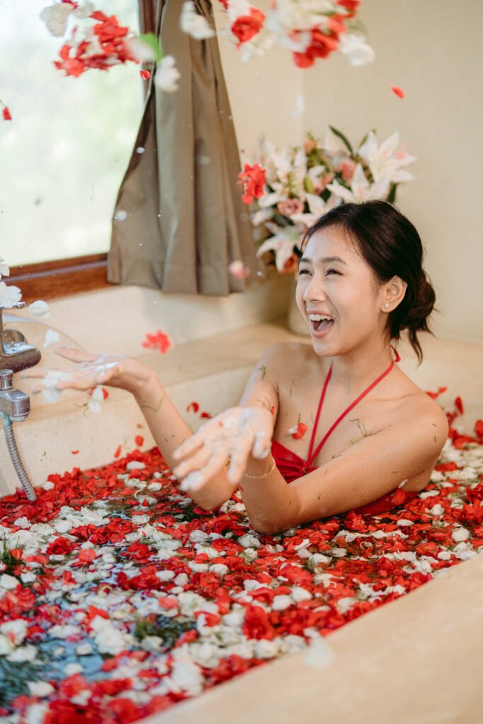 Woman in flower-filled bathtub.