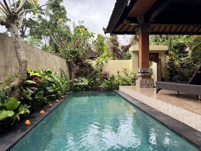 Tropical pool surrounded by lush greenery called Blue Lotus Ubud